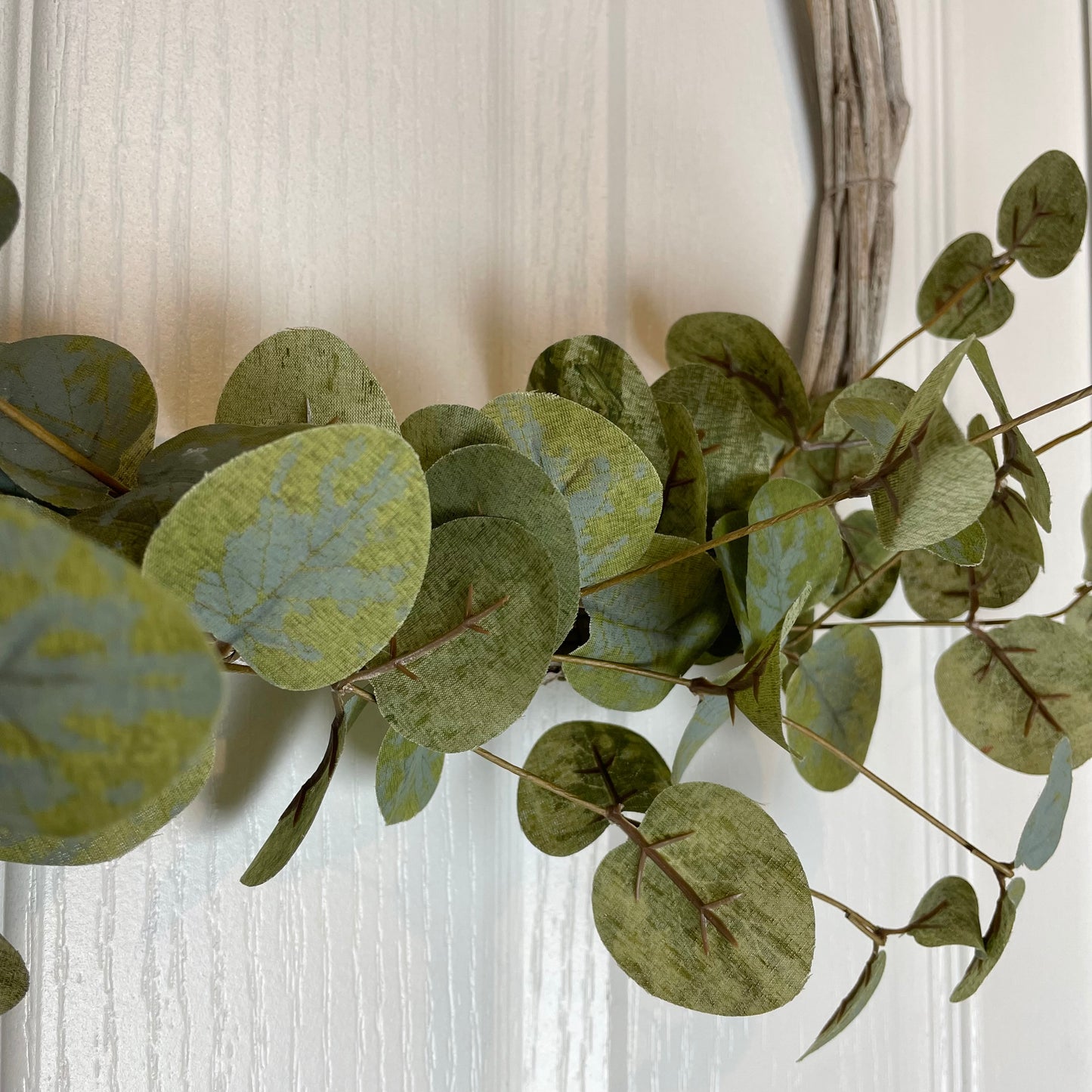 Beautiful faux eucalyptus wreath on a twig hoop frame.