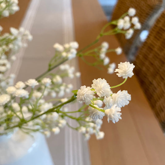 Faux white gypsophila stems arranged in a vase, styled with five stems