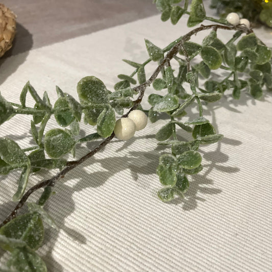 Elegant festive garland with white berries styled on a dining table.