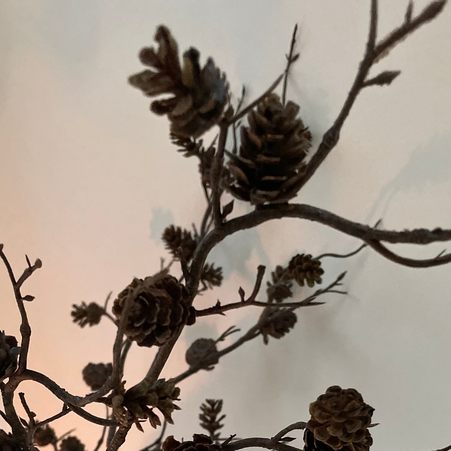 Natural faux mini pine cone branch for festive arrangements.