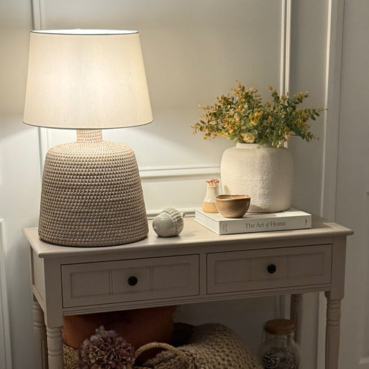 Handwoven rattan table lamp with whitewashed finish, available with or without shade.