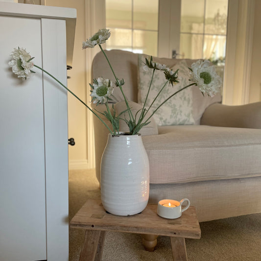 Faux Scabiosa Stem with off white flowers and soft green centres, styled in a neutral glazed vase