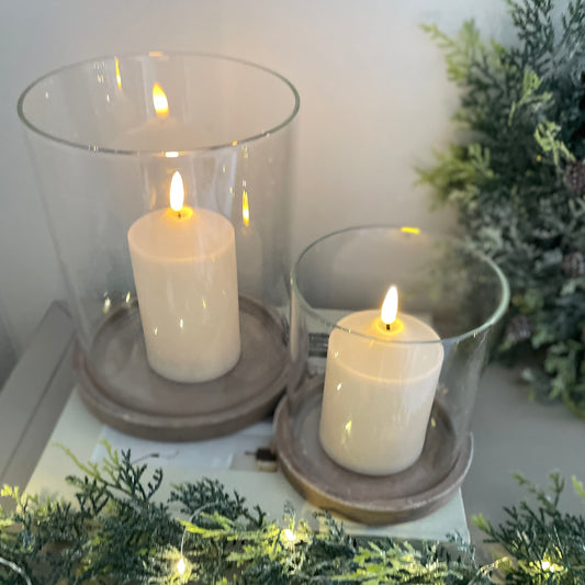 Sienna hurricane with earthy base and glass shade styled on a wooden console table.