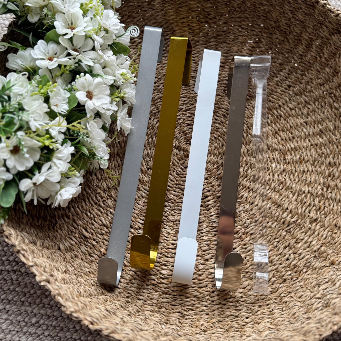 Assorted coloured metal wreath holders displayed together, showcasing their sturdy design and versatile home decor use.