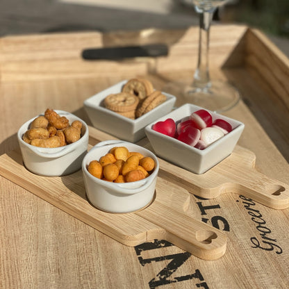Bamboo serving board set with white dishes, ideal for home entertaining and stylish presentation