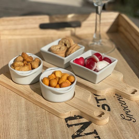 Bamboo serving board set with white dishes, ideal for home entertaining and stylish presentation