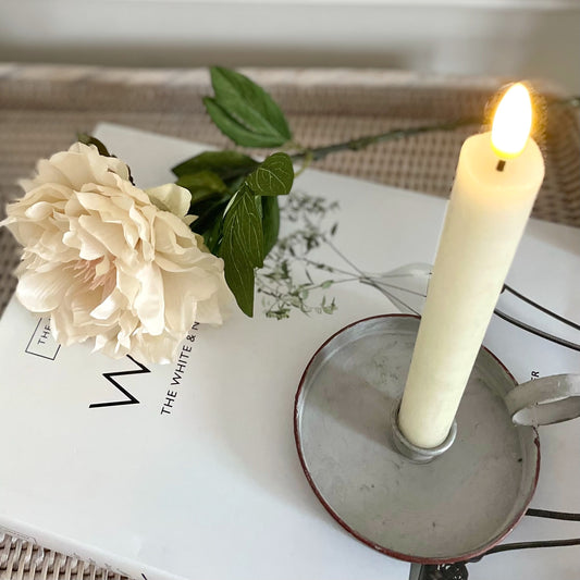LED dinner candle with realistic flickering flame, 24 cm tall, styled on a dining table with a book.