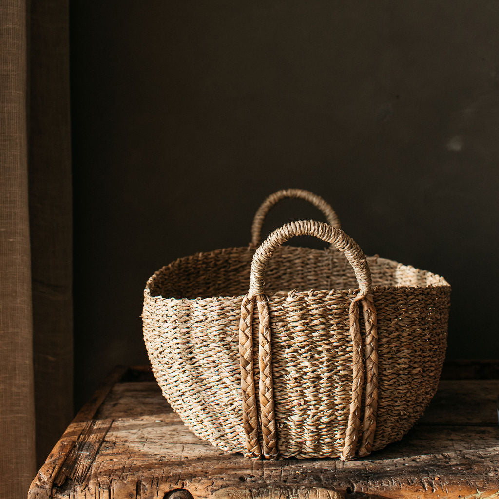 Natural seagrass storage basket with braided handles, adding a warm, textured touch to your home while keeping spaces organised.