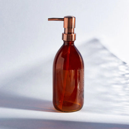 Stylish amber glass bottle helping reduce single use plastic, perfect for soap or lotion.