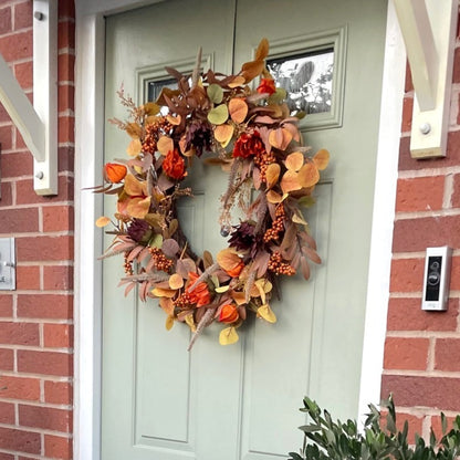 Sacha Autumn Wreath with russet faux foliage, berry sprigs and autumn flowers on a large grapevine base, styled on a front door.