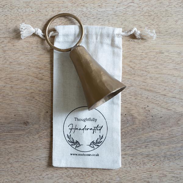Candle snuffer on cotton presentation gift bag shown on a wooden table.
