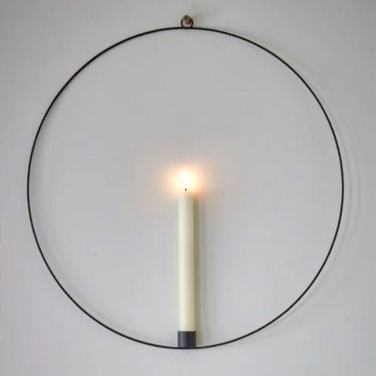 Warm white LED battery operated wax effect candle in a hanging black metal ring with remote control.