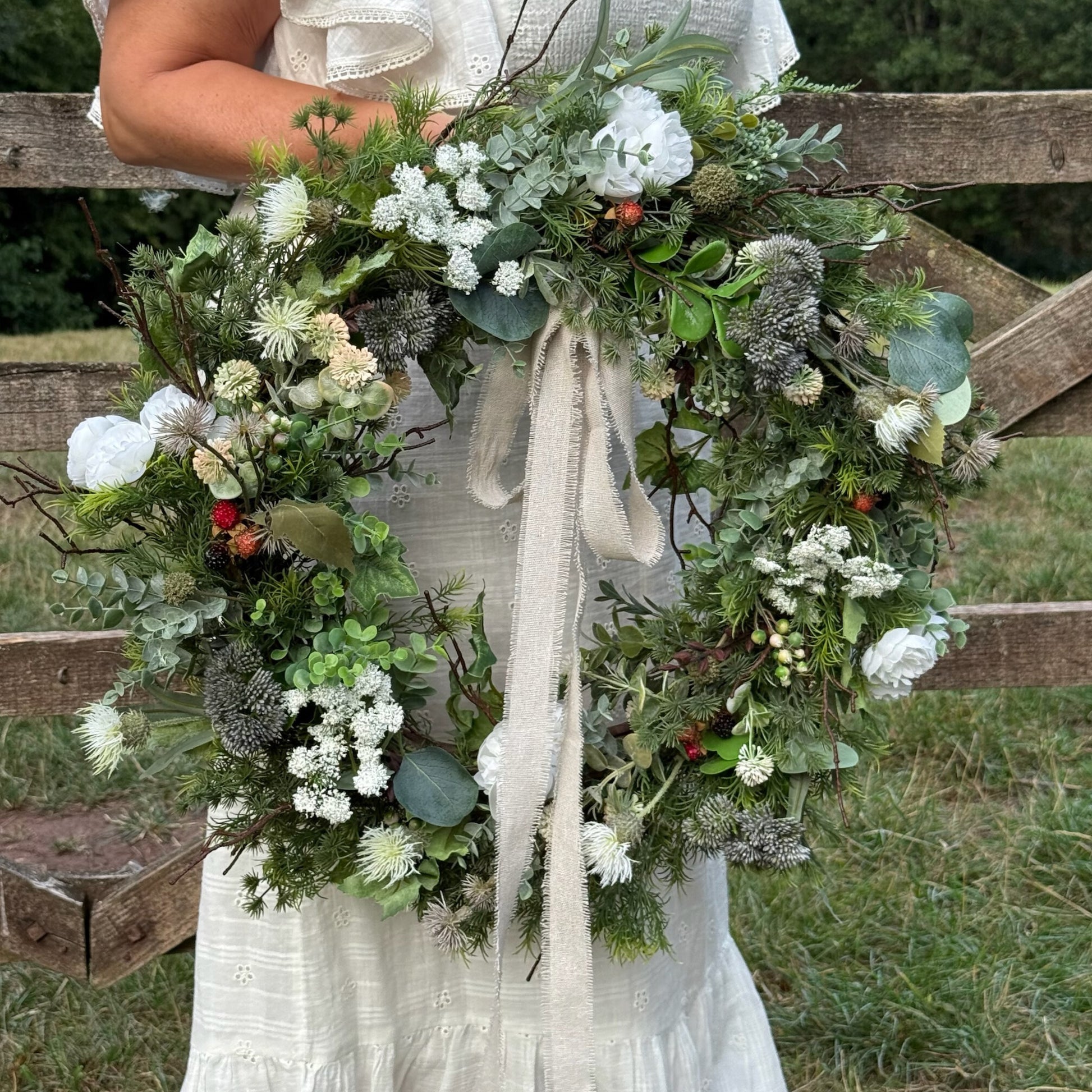 Handmade faux wreath featuring blackberries, wild thistles, ranunculus flowers and lush foliage, inspired by countryside bramble picking and nature’s quiet beauty.