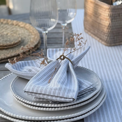 Textured napkin rings on a neutral table setting, adding simple elegance and space for flowers or greenery to suit any season.