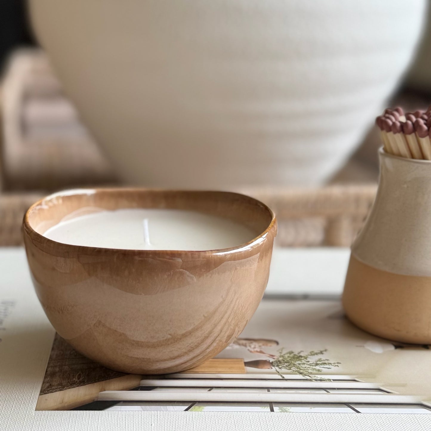 Decorative candle in a ceramic pot, designed to be enjoyed and reused for home styling once burned.