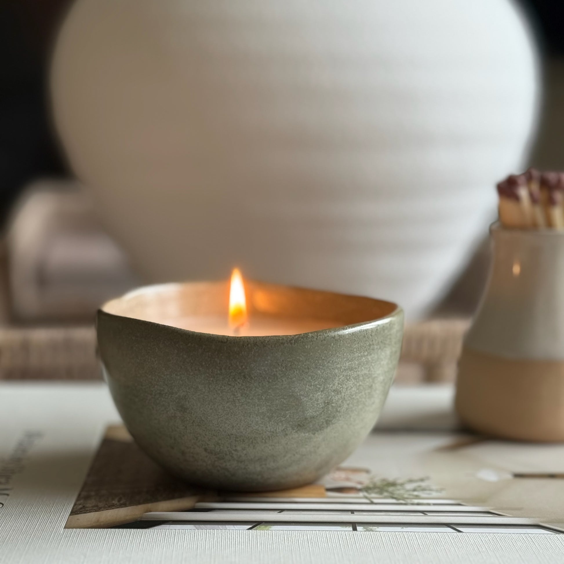 Decorative candle in a ceramic pot, designed to be enjoyed and reused for home styling once burned.