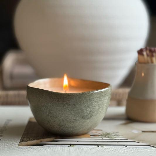 Decorative candle in a ceramic pot, designed to be enjoyed and reused for home styling once burned.