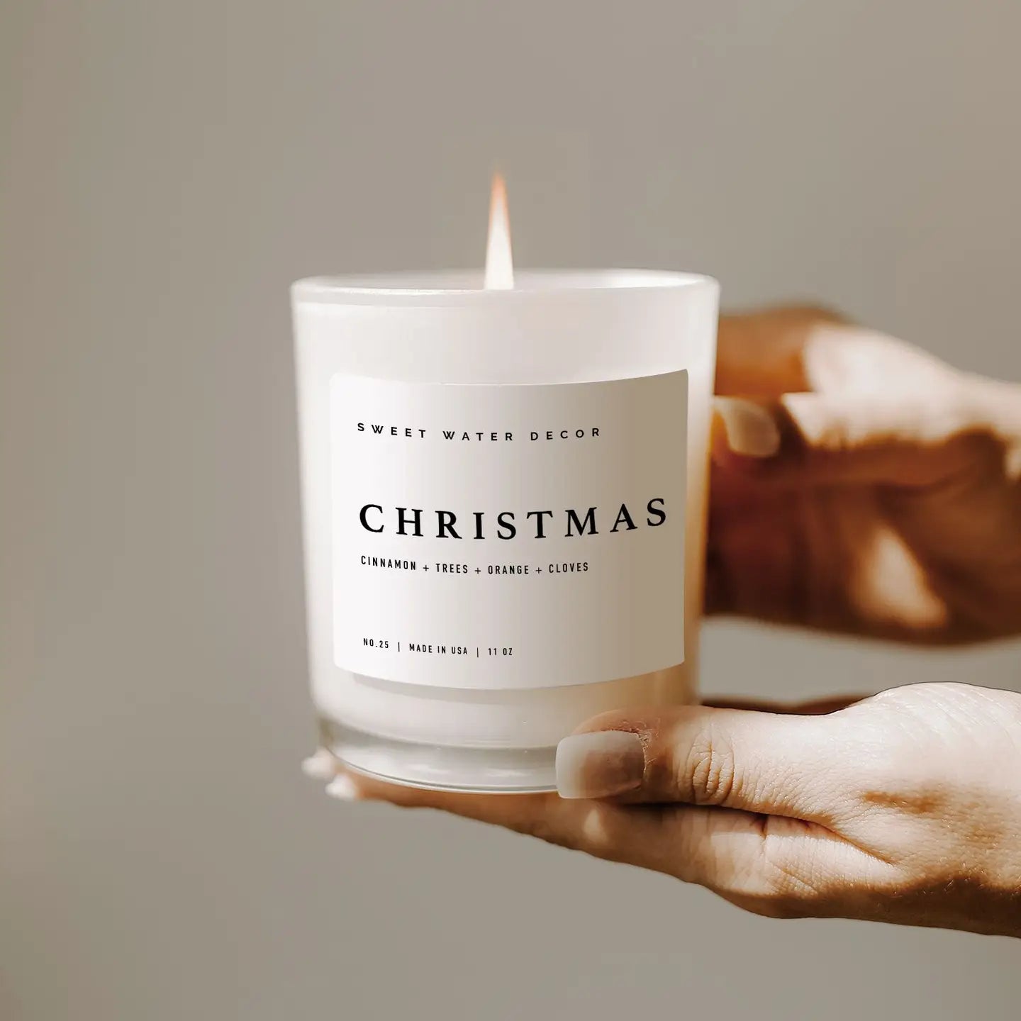 Festive Christmas soy wax candle with cotton wick. Shown in a white frosted glass holder.