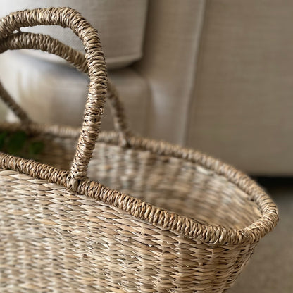 Close up of seagrass shopper basket. Handwoven details with handles.