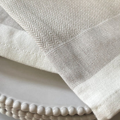 Close up of herringbone weave on taupe cotton napkin. 