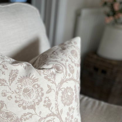 Taupe patterned cushion with a subtle country inspired print, styled on a neutral sofa.