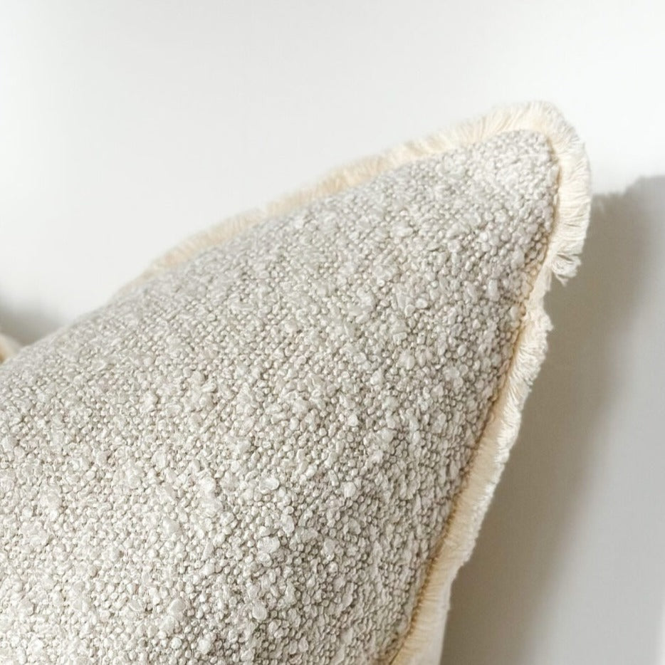 Textured boucle cream cushion in a soft neutral tone, adding warmth and style to a living room.