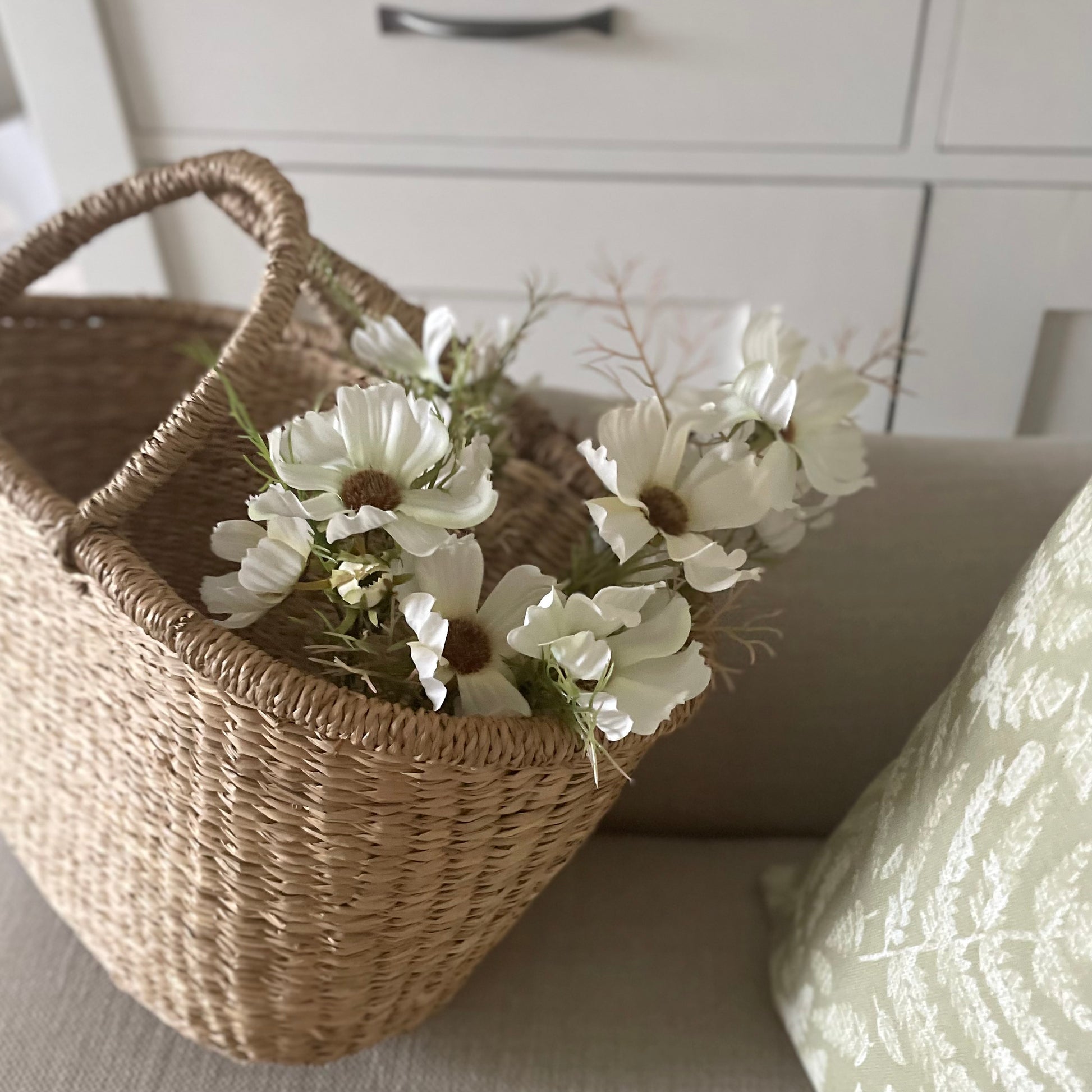 Cream Cosmos Spray with 16 realistic flower heads and buds. Styled in a seagrass shopper.