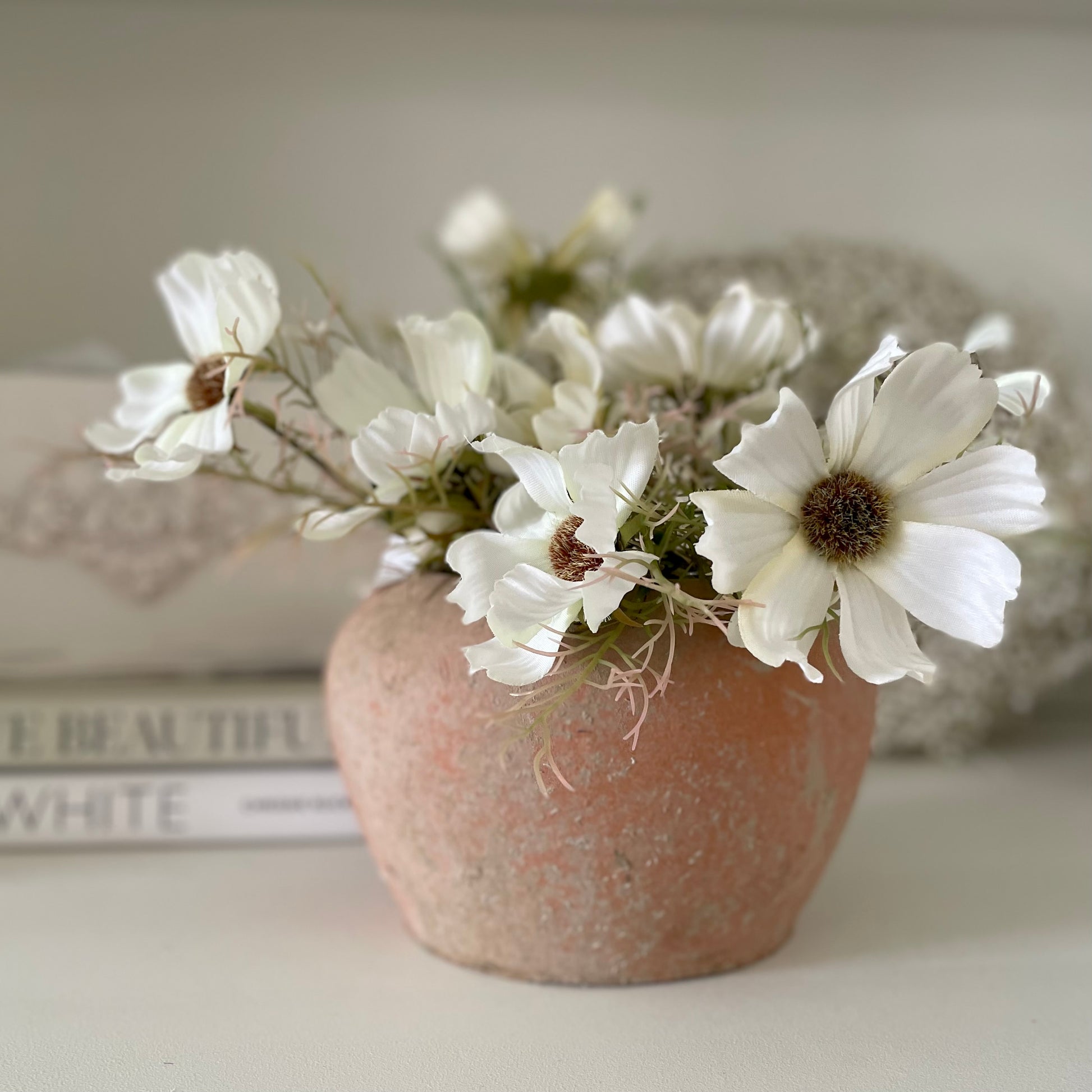 Cream Cosmos Spray with 16 realistic flower heads and buds. Styled in a terracota pot.