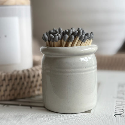 Ceramic match striker pot with hand-painted glaze and matches, perfect for styling on a mantel or gifting to a home lover.