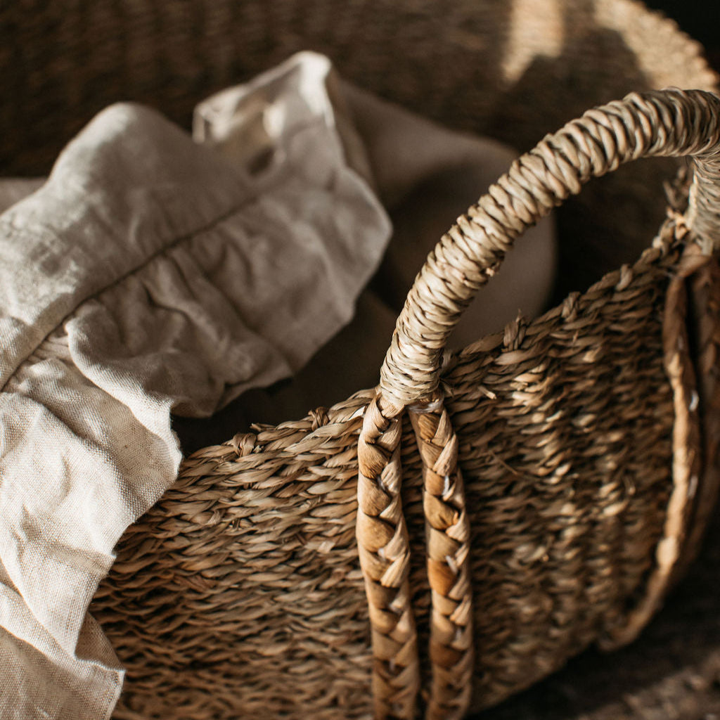 Handwoven deep oval basket made from natural seagrass, combining rustic texture with refined, practical design for any room.