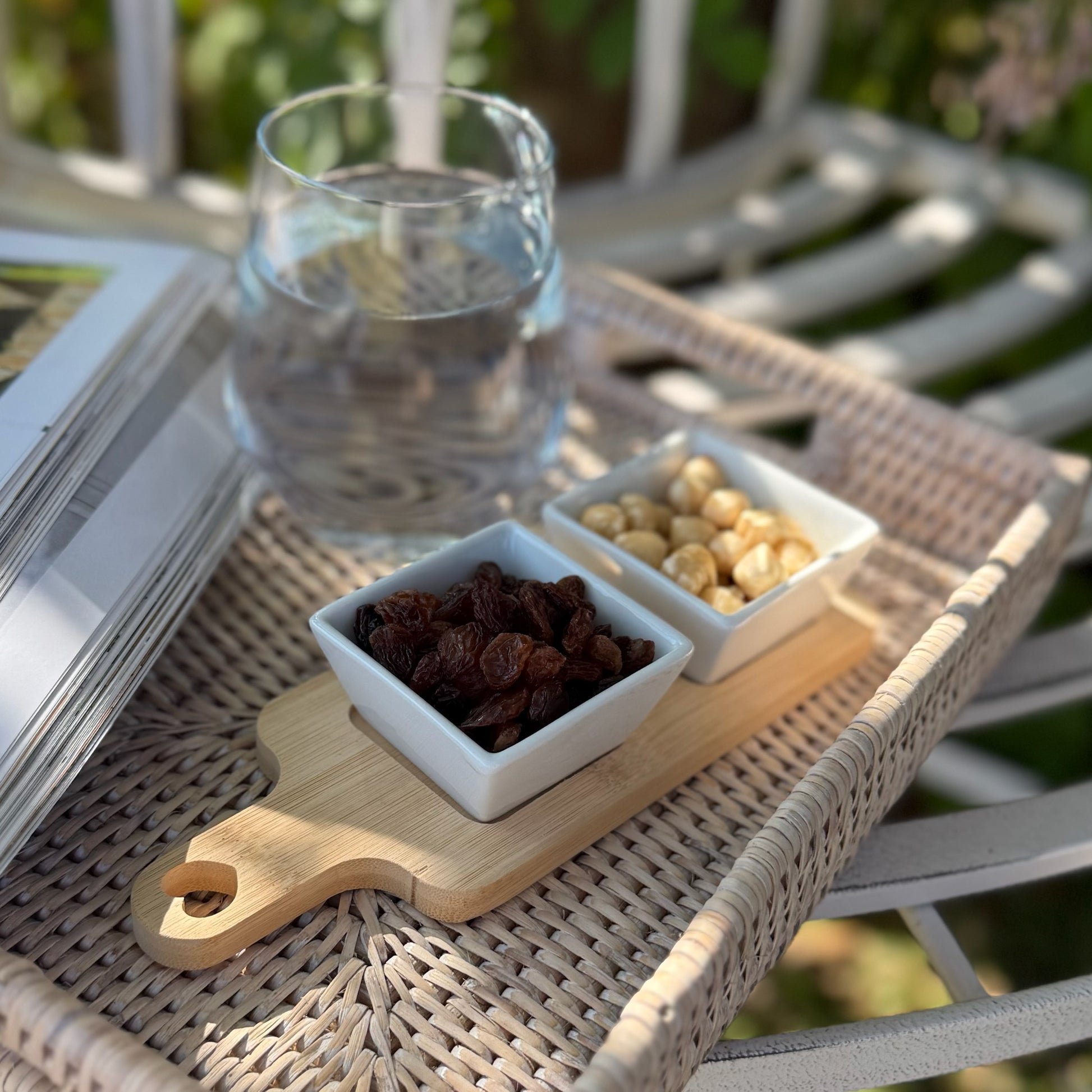 Square oriental inspired bamboo board with double dipping dishes, perfect for serving snacks or dips.
