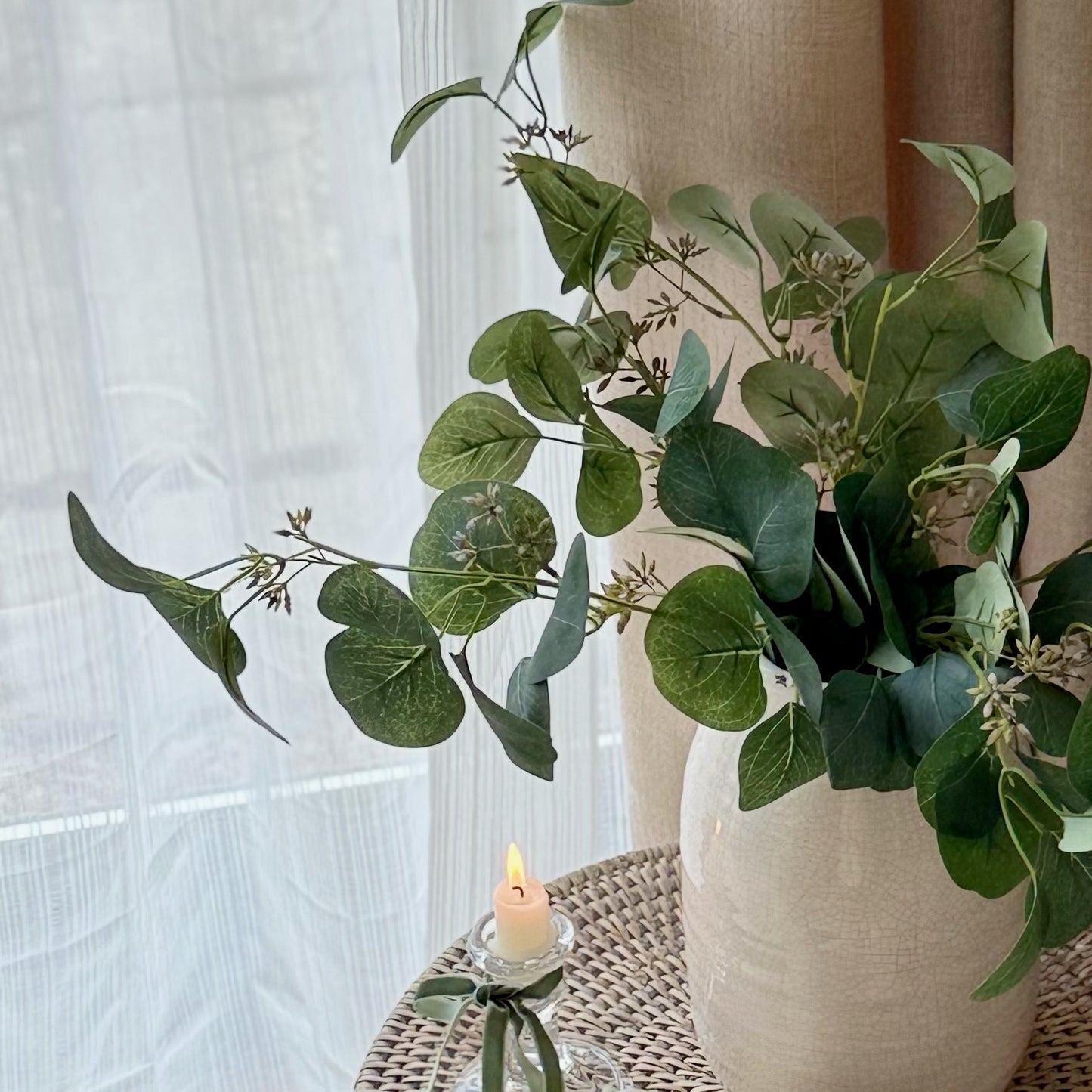 Faux eucalyptus spray with soft green leaves and delicate berries, styled in a vase for a calm, timeless look.