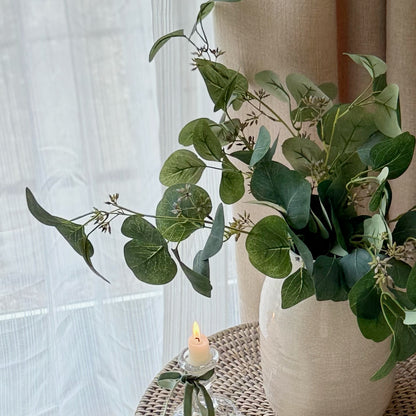 Faux eucalyptus spray with soft green leaves and delicate berries, styled in a vase for a calm, timeless look.
