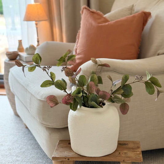 Artificial foliage stem with soft greens and ruby tones, perfect for vase or floral arrangements