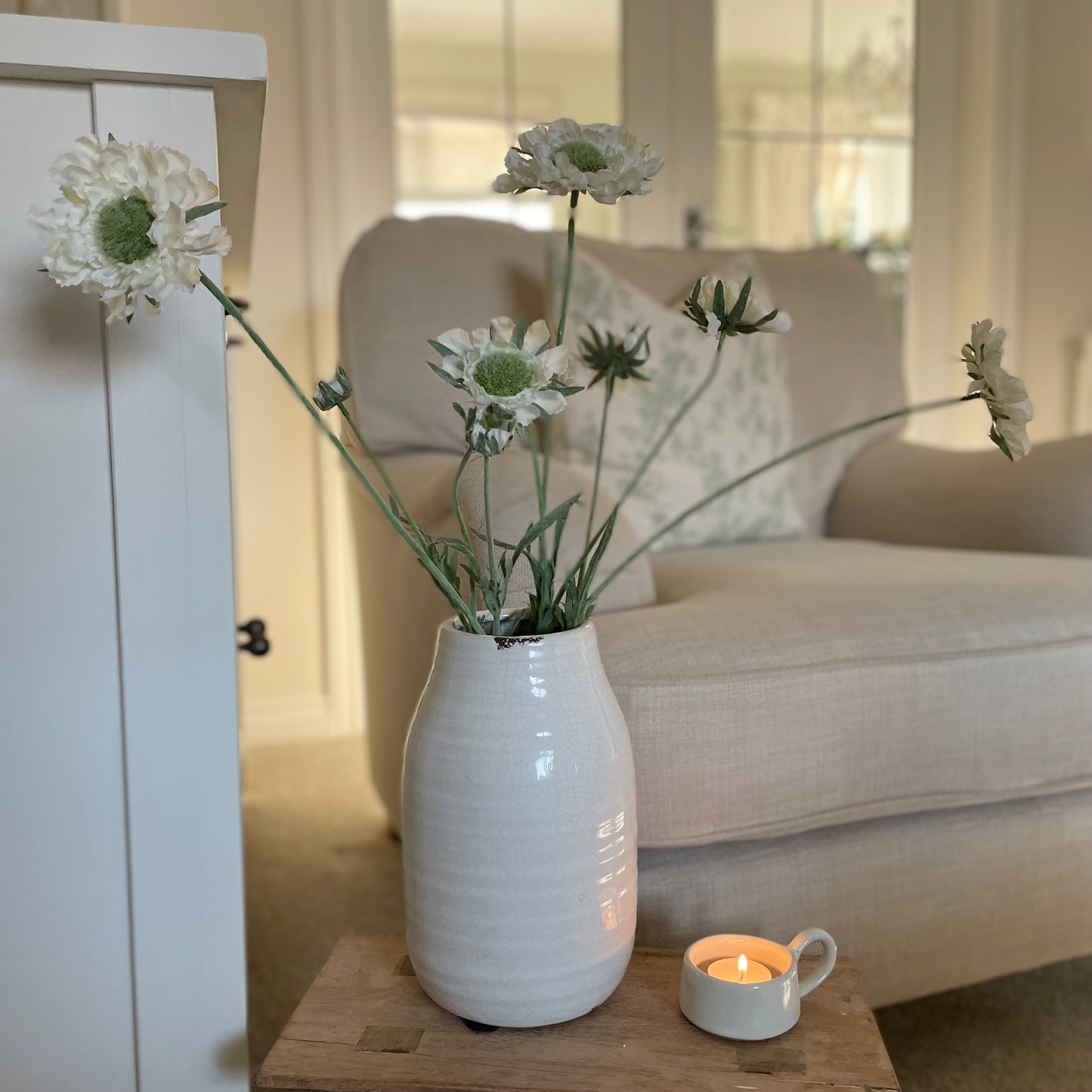 Faux Scabiosa Stem with off-white flowers and soft green centres, styled in a cream glazed vase