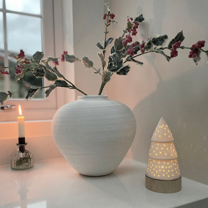 Frosted holly stem with red berries styled in stone white vase, festive faux foliage 68 cm.