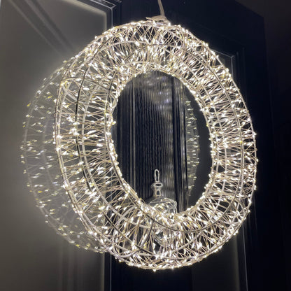 Close up of shimmering LED Galaxy wreath twinkling on a front door.