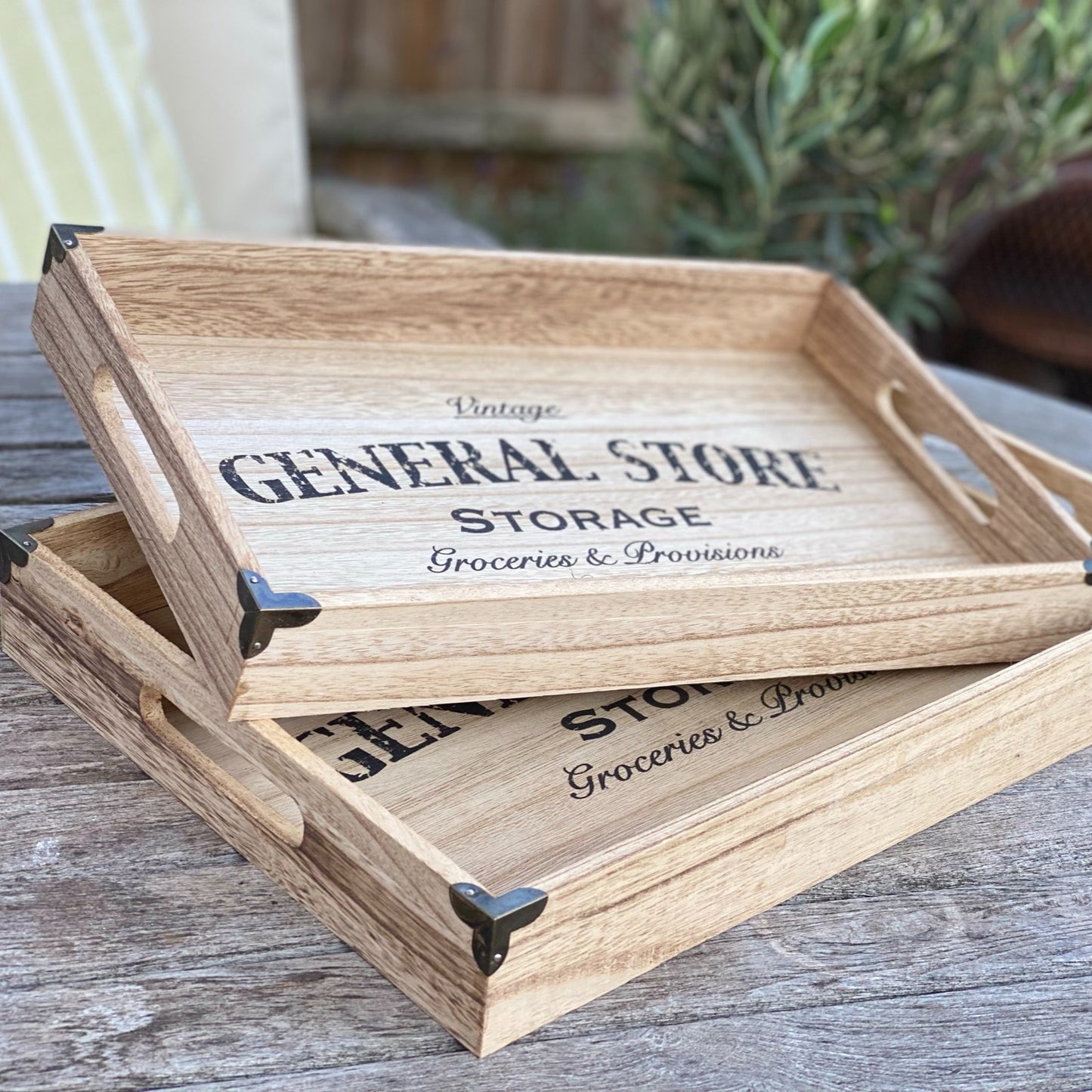 Set of 2 industrial wooden trays with metal corners and “General Store” print styled on a table.