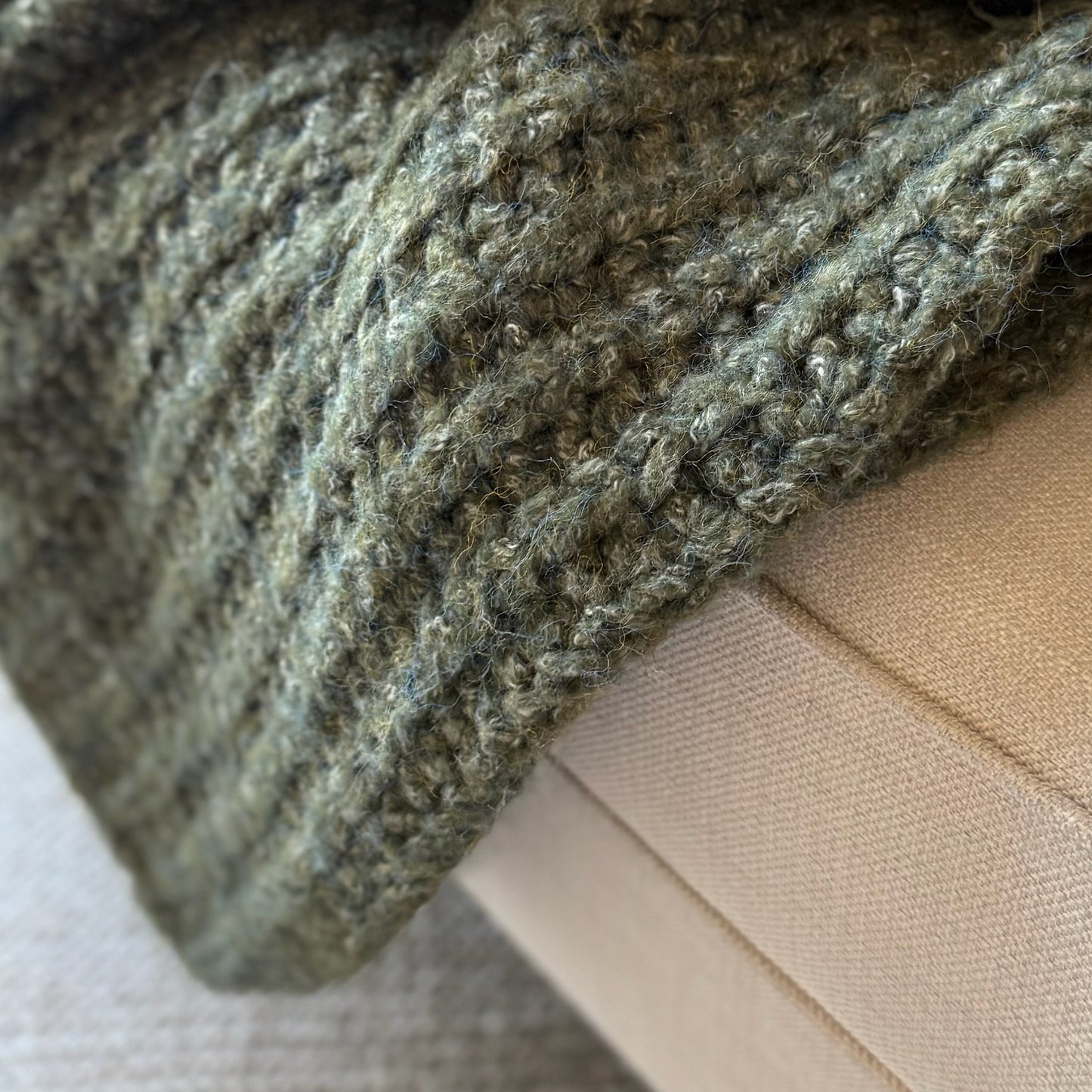 Decorative deep green throw with rich melange texture, perfect for cosy layering in neutral or seasonal interiors.