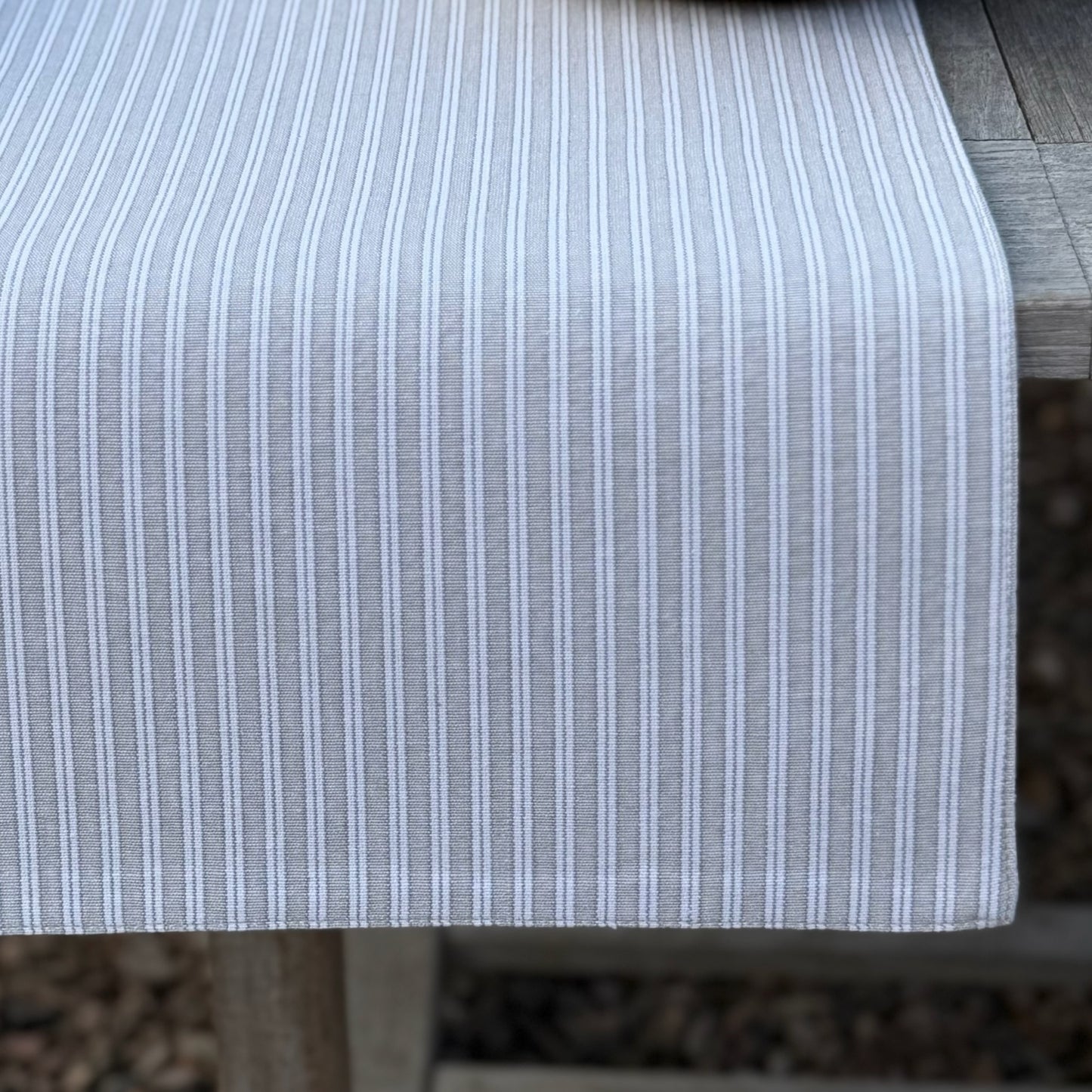 Grey and white striped table runner for alfresco dining and relaxed dining.