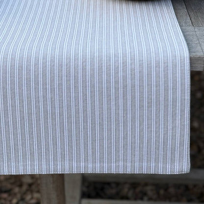 Grey and white striped table runner for alfresco dining and relaxed dining.
