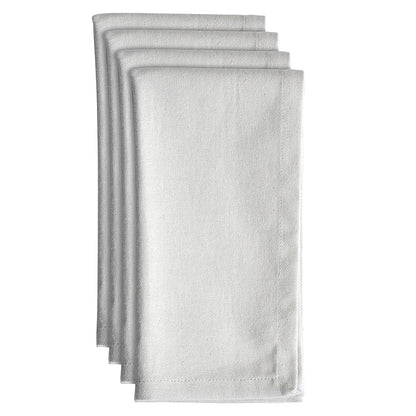 Set of four light grey cotton napkins neatly folded on a white background.