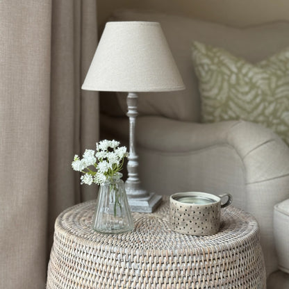 Minimalist small lamp with neutral linen shade, perfect for creating a relaxed, warm ambiance on shelves or sideboards.