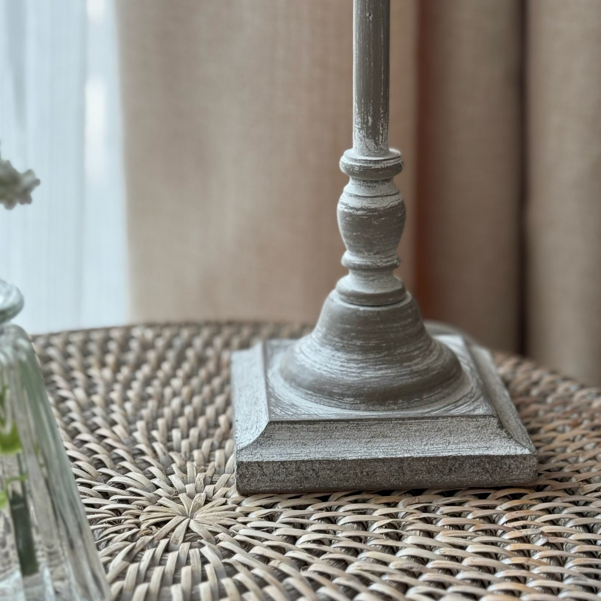 Decorative table lamp with sleek stem and soft linen shade, adding cosy, calming light to a living space.