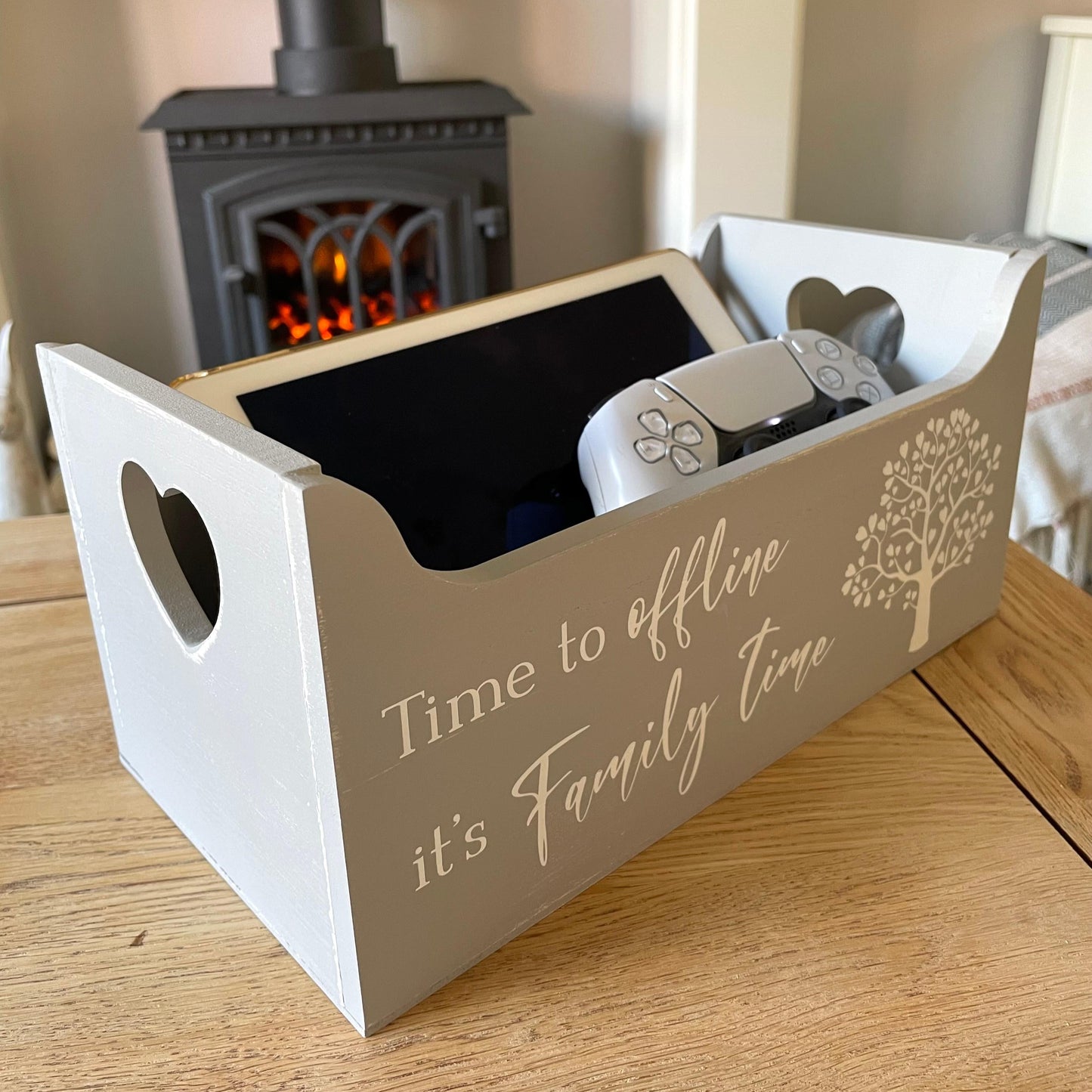 Decorative box with 'Time to offline, it's family time' text on a wooden coffee table.