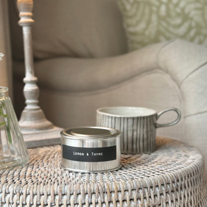 Candle and mug candle holder on a rattan table and lamp.