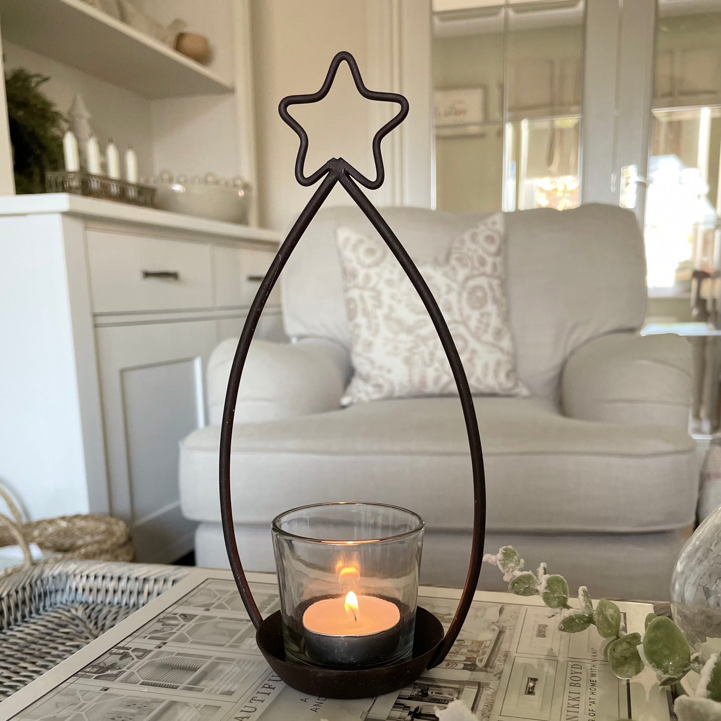 Metal star shaped tea light holder with glass votive.