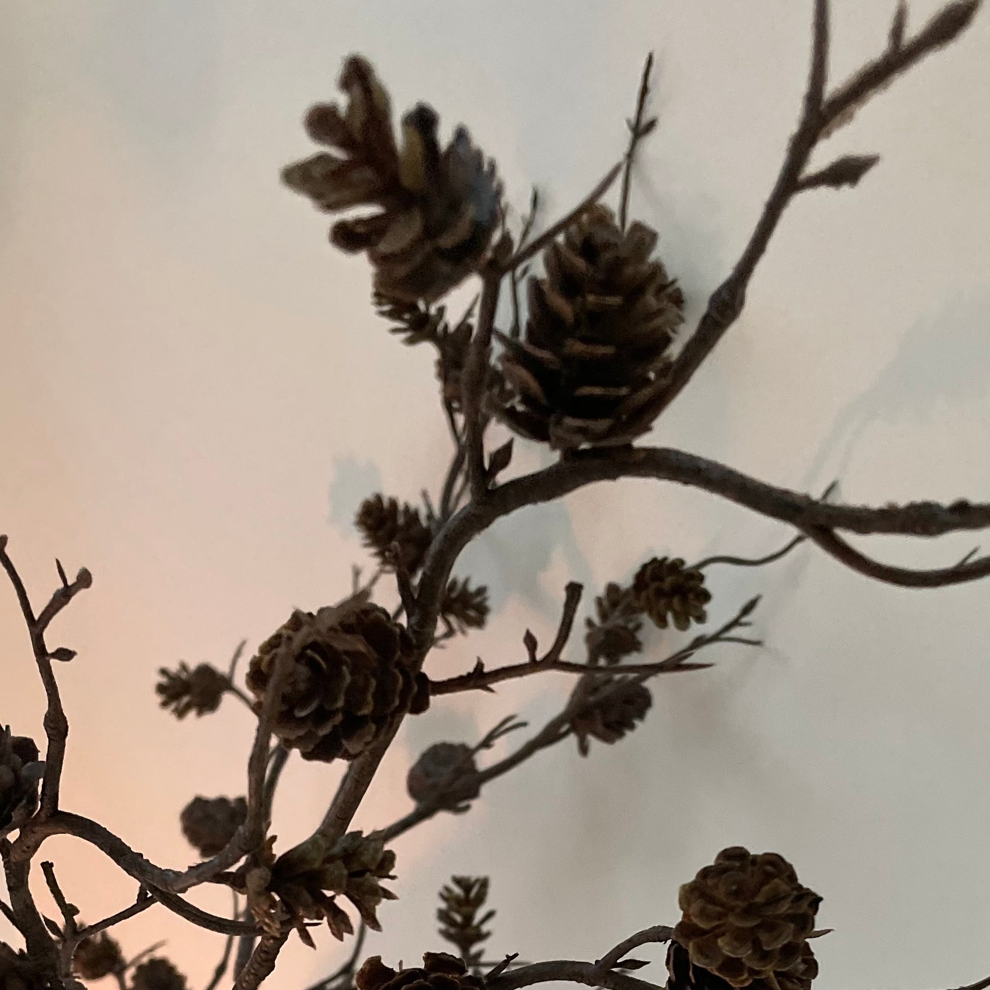 Natural faux mini pine cone branch for festive arrangements.