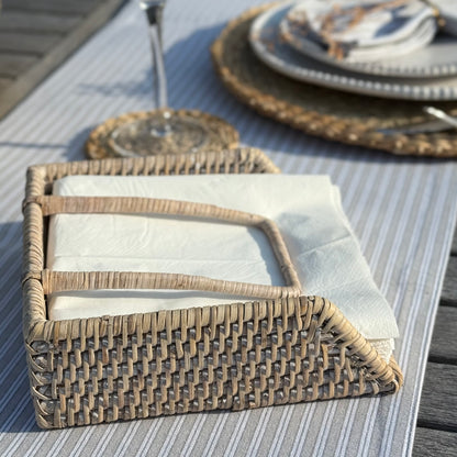 Handwoven rattan napkin holder with weighted arm, perfect for everyday dining and kitchen styling.