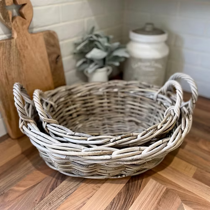 Wicker basket on a wooden surface with a kitchen background
